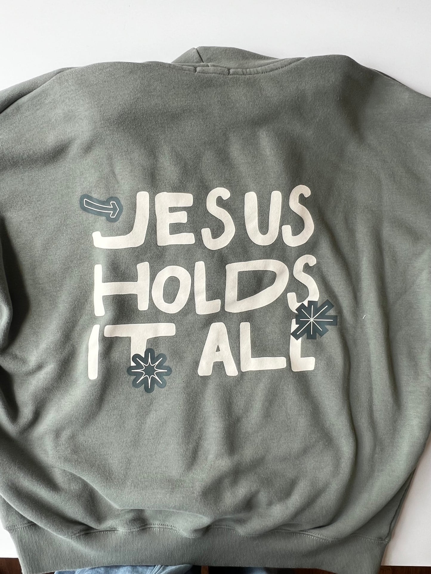 JESUS HOLDS IT ALL HOODIE L